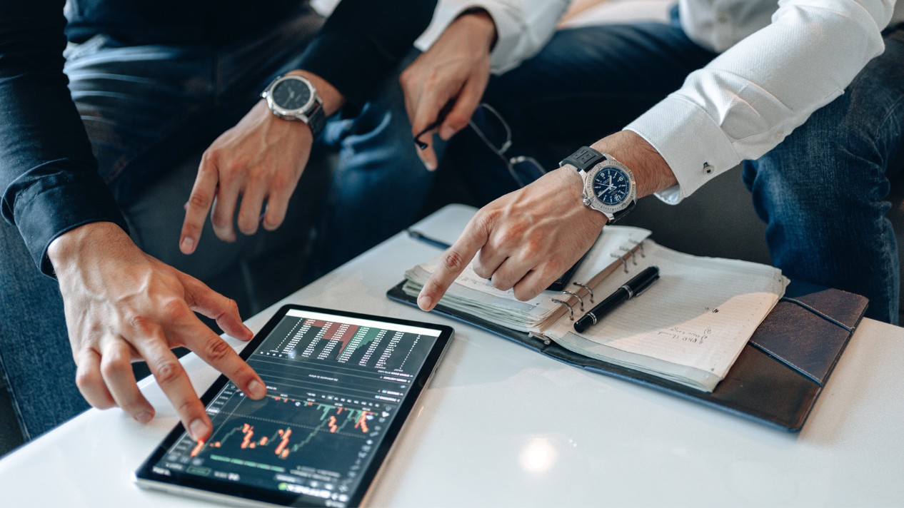 finance professionals analyze stock market